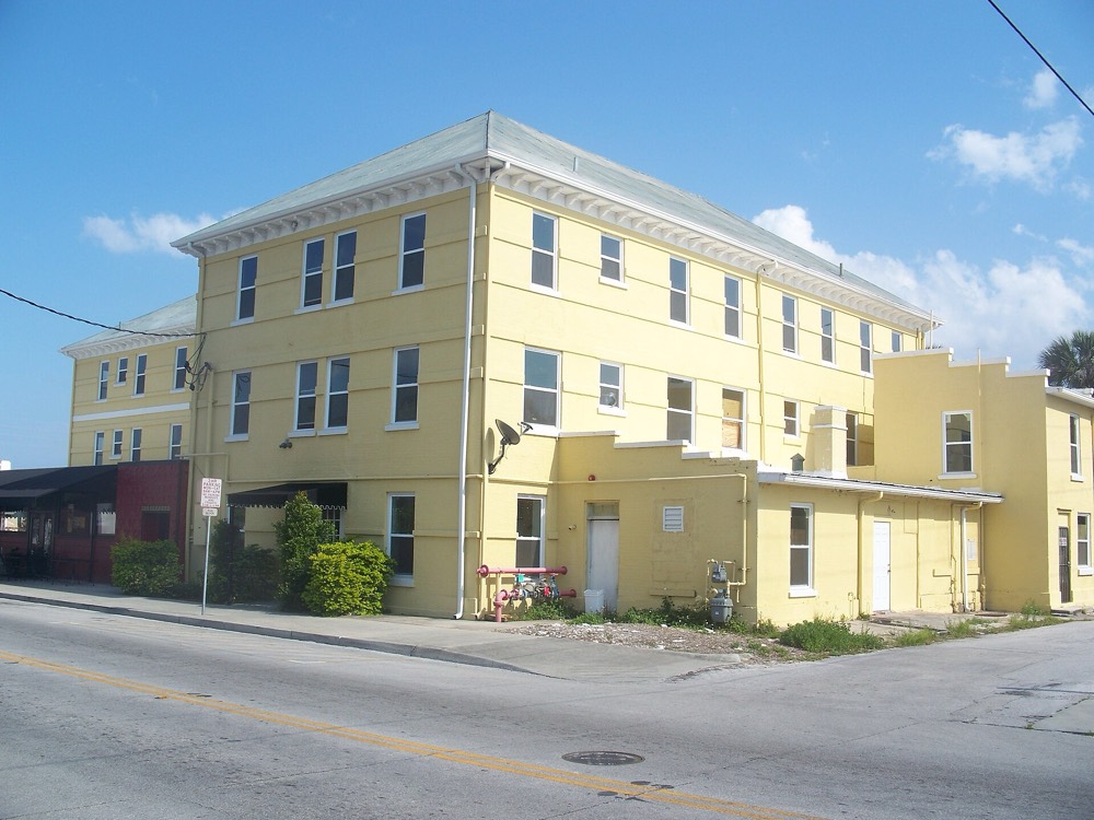 The yellow three-story St. Cloud Hotel building on a downtown street corner